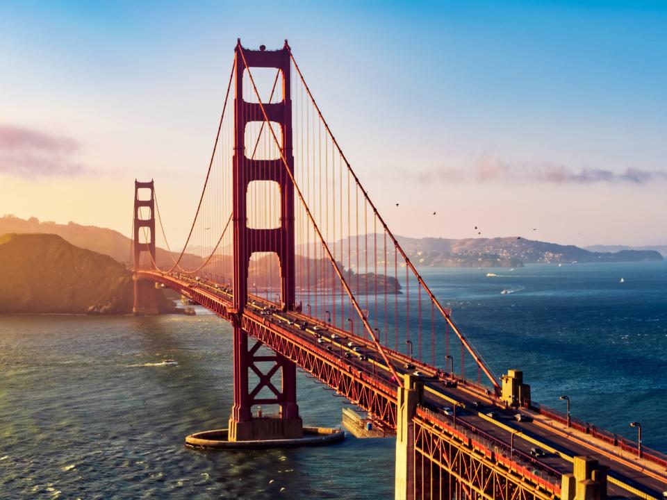 Aerial view of traffic moving on Golden Gate Bridge during sunset, San Francisco, California.