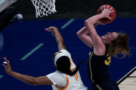 Michigan center Izabel Varejao, left, gets past Tennessee center Kasiyahna Kushkituah (11) to put up a shot during the first half of a college basketball game in the second round of the women's NCAA tournament at the Alamodome in San Antonio, Tuesday, March 23, 2021. (AP Photo/Charlie Riedel)