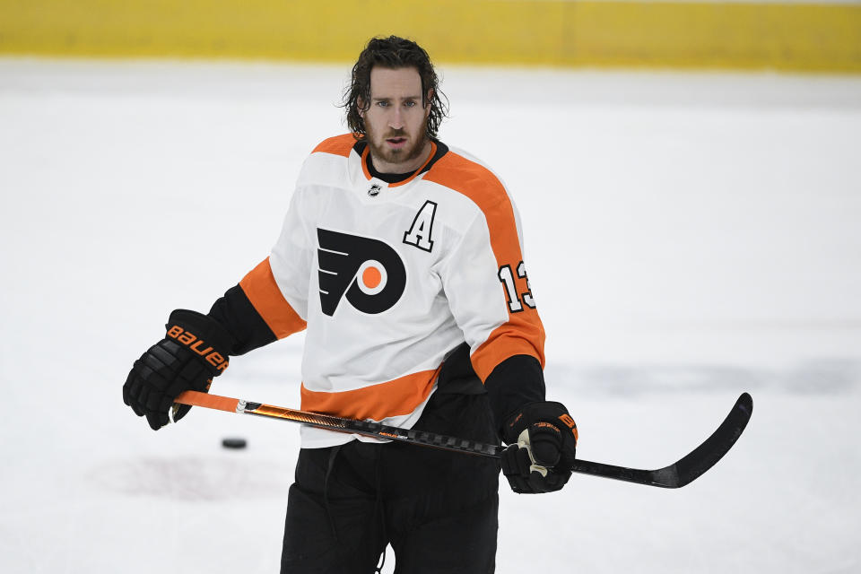 FILE - Philadelphia Flyers center Kevin Hayes (13) warms up before an NHL hockey game against the Washington Capitals in Washington, in this Tuesday, April 13, 2021, file photo. Kevin Hayes spent a life in step with big brother Jimmy, a couple of kids from Boston's largest neighborhood who attended the same boarding school, same college and, ultimately, played head-to-head in the NHL. In August, Kevin Hayes stood behind to a lectern inside a jammed Catholic parish, steeled his nerves and told mourners about the best brother in the world. (AP Photo/Nick Wass, File)