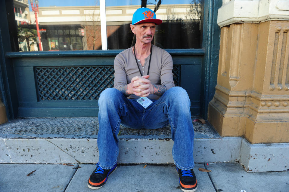 In this Wednesday, March 12, 2014 photo, former heroin addict David Fitzgerald sits outside the rehabilitation clinic where he works in Portland, Ore. Fitzgerald knows that many of the clients he sees at 25 may be back in rehab at 35, but he tries to remain optimistic that some of what they learn at Central City will, ultimately, make a difference. "That's about all you can do," he says, "hope some of it sticks." (AP Photo/Steve Dykes)