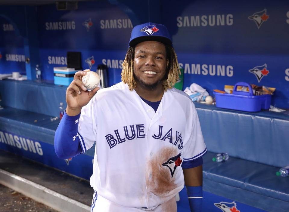 TORONTO, ON - APRIL 26: Vladimir Guerrero Jr. #27 of the Toronto Blue Jays holds the baseball he hit for his first MLB career hit during MLB game action against the Oakland Athletics at Rogers Centre on April 26, 2019 in Toronto, Canada. (Photo by Tom Szczerbowski/Getty Images)