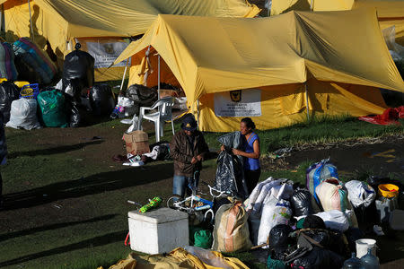 A Venezuelan migrant family arranges their belongings at a tent inside a temporary humanitarian camp that is closed by the government, in Bogota, Colombia January 15, 2019. REUTERS/Luisa Gonzalez