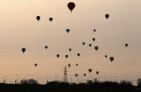 WOOTTON, UNITED KINGDOM - APRIL 07: Hot air balloons depart from Lydden Hill race circuit near Canterbury to take part in a mass crossing of the Channel on April 7, 2011 in Wootton, England. 51 balloonists of various nationalities from across Europe took off from Kent making for Calais, France at about 7am. It is the first time a Guinness World Record bid has been made for "the largest group of hot air balloons to make the Channel crossing". (Photo by Oli Scarff/Getty Images)