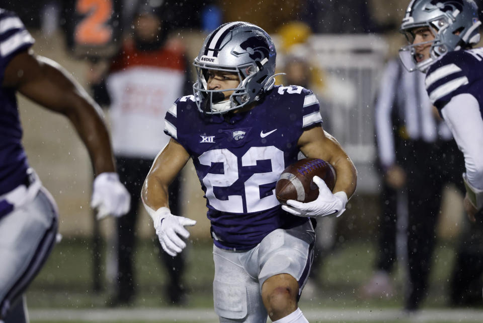 Kansas State running back Deuce Vaughn (22) rushes for yardage during the first quarter of an NCAA college football game against Kansas on Saturday, Nov. 26, 2022, in Manhattan, Kan. (AP Photo/Colin E. Braley)