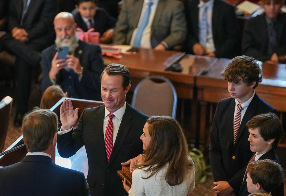 Speaker of the House Dade Phelan, R-Beaumont, center, stands with his wife Kim and sons as he is sworn in as Speaker of the House by Judge Jeff Branick during the first day of the 88th Texas Legislative Session in Austin, Texas, Tuesday, Jan. 10, 2023.