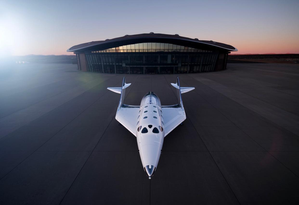 Virgin Galactic's Unity spaceship in front of the Gateway to Space terminal and hangar it leases at Spaceport America.