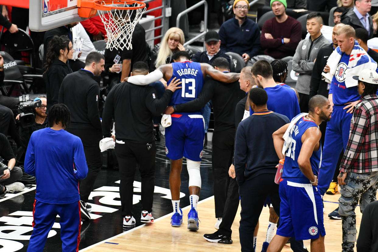 LOS ANGELES, CALIFORNIA - MARCH 21: Paul George #13 of the Los Angeles Clippers suffers an apparent knee injury during a basketball game against the Oklahoma City Thunder at Crypto.com Arena on March 21, 2023 in Los Angeles, California. NOTE TO USER: User expressly acknowledges and agrees that, by downloading and/or using this Photograph, user is consenting to the terms and conditions of the Getty Images License Agreement. (Photo by Allen Berezovsky/Getty Images)