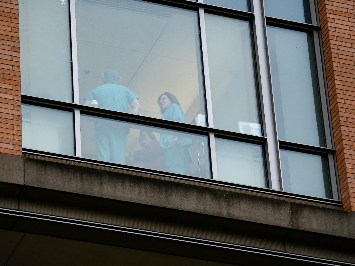 FILE PHOTO: Employees dressed in scrubs talk with each other at Providence Regional Medical Center after a spokesman from the U.S. Centers for Disease Control and Prevention (CDC) said a traveler from China has been the first person in the United States to be diagnosed with the Wuhan coronavirus, in Everett, Washington, U.S. January 21, 2020.  REUTERS/Lindsey Wasson