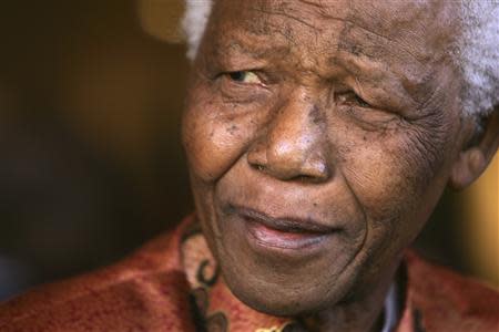 Former South African President Nelson Mandela smiles as he formally announces his retirement from public life at his foundation's offices in Johannesburg in this June 1, 2004 file photo. REUTERS/Mike Hutchings/Files