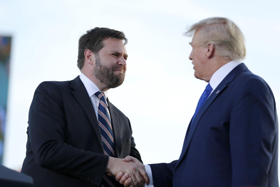 FILE - Senate candidate JD Vance, left, greets former President Donald Trump at a rally at the Delaware County Fairgrounds, Saturday, April 23, 2022, in Delaware, Ohio, to endorse Republican candidates ahead of the Ohio primary on May 3. On Tuesday voters in Ohio choose between the Trump-backed JD Vance for an open U.S. Senate seat and several other contenders who spent months clamoring for the former president's support. (AP Photo/Joe Maiorana, File)