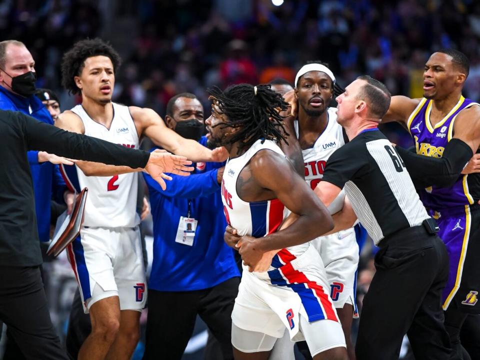 Detroit Pistons forward Isaiah Stewart, centre, is restrained while attempting to confront Los Angeles Lakers' LeBron James during a game on Sunday. (Nic Antaya/Getty Images - image credit)