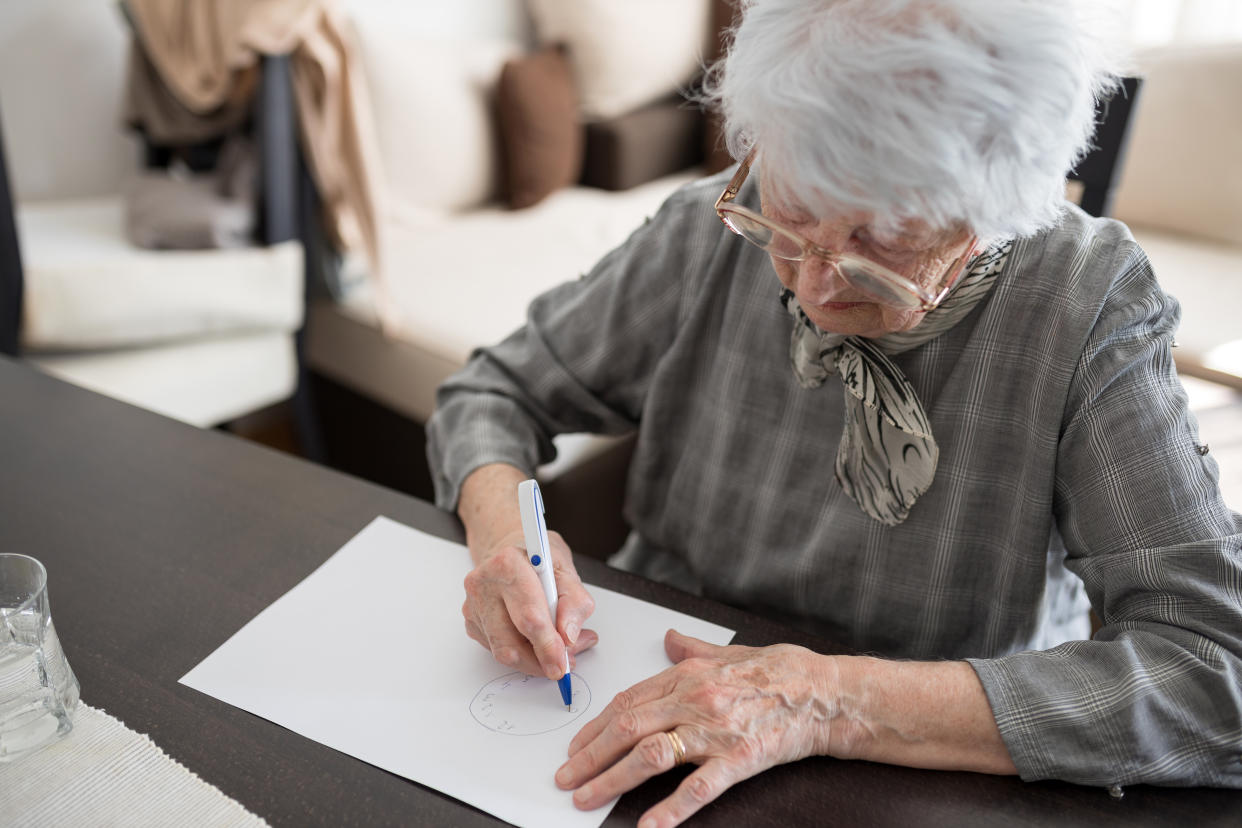 A woman taking an Alzheimer's disease cognitive function test.