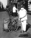 A New York city street sweeper wears a mask to help check the spread of the influenza epidemic, October 1918. In the view of one official of the New York Health Board, it is 'Better be ridiculous, than dead'. (Photo by PhotoQuest/Getty Images)