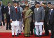 Bangladesh's Prime Minister Sheikh Hasina (C) waves to the media upon her arrival for the 18th South Asian Association for Regional Cooperation (SAARC) summit in Kathmandu November 25, 2014. REUTERS/Navesh Chitrakar