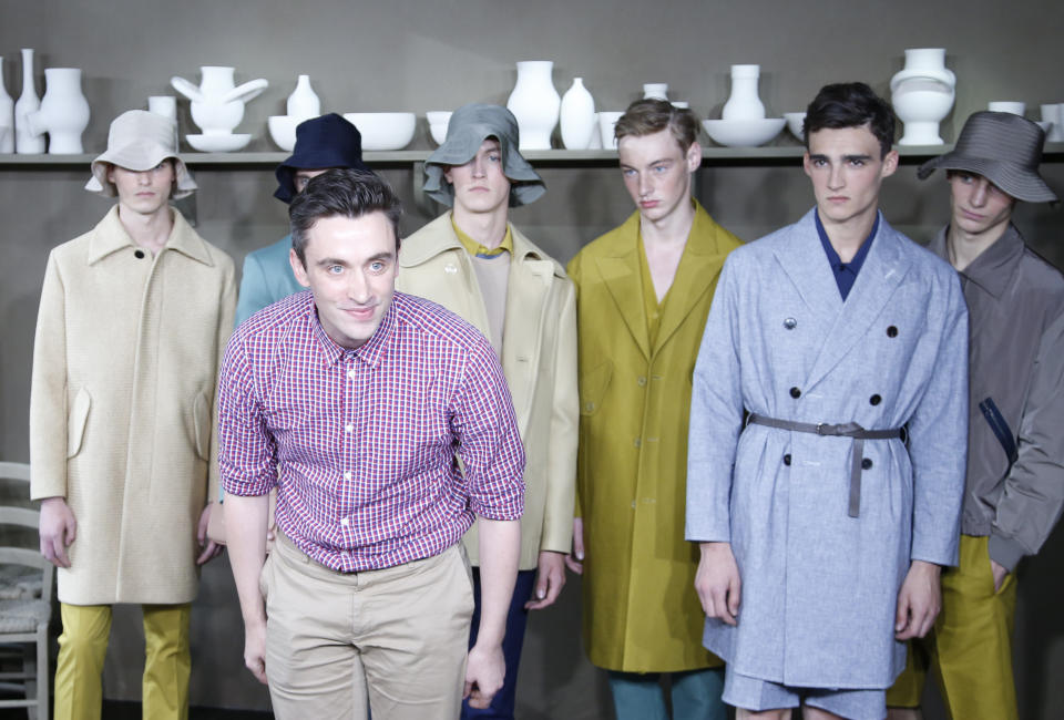 Carven creative director Guillaume Henry, of France, acknowledges applause after the presentation of Carven's men fashion Spring-Summer 2014 collection, Wednesday, June 26, 2013 in Paris. (AP Photo/Francois Mori)