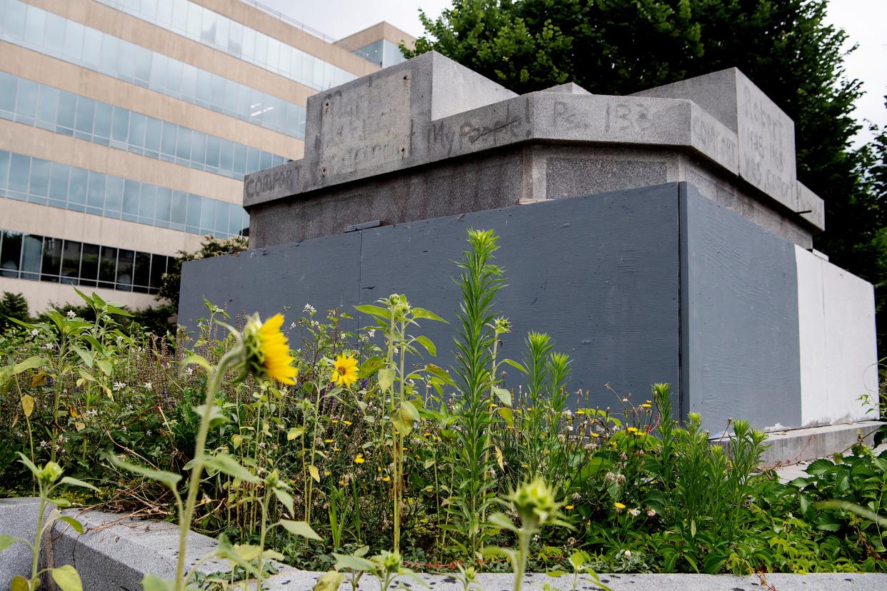 Sunflowers grow at the base of what is left of Vance Monument in Pack Square June 14, 2022 in Asheville.