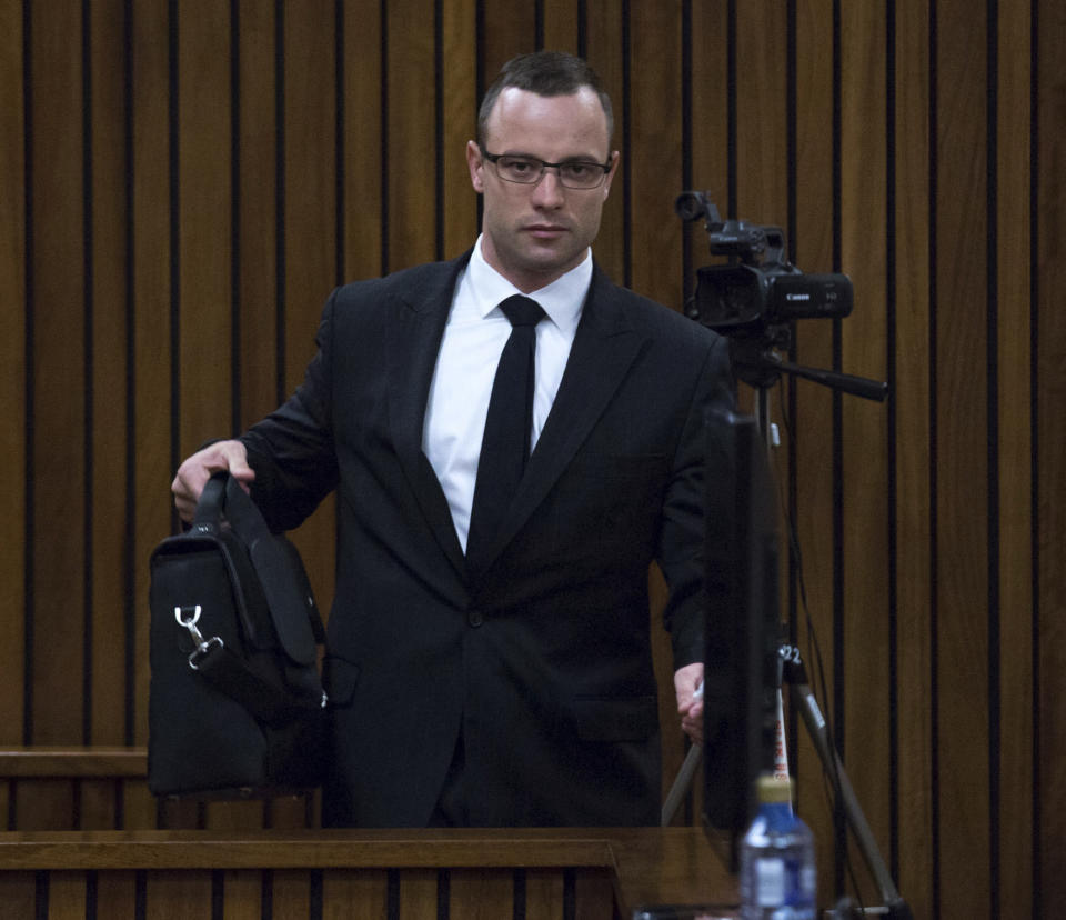 Oscar Pistorius arrives at a courtroom for his ongoing murder trial at the high court in Pretoria, South Africa, Tuesday, May 13, 2014. Pistorius is charged with the shooting death of his girlfriend Reeva Steenkamp on Valentine's Day in 2013. (AP Photo/Daniel Born, Pool)