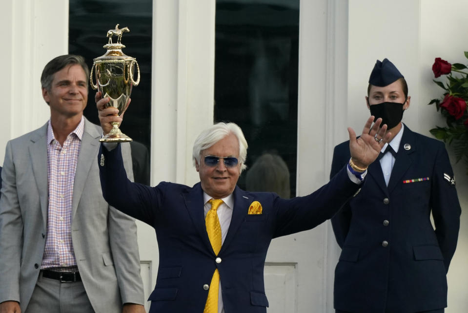 Trainer Bob Baffert holds the trophy after John Velazquez rode Authentic to victory in the 146th running of the Kentucky Derby at Churchill Downs, Saturday, Sept. 5, 2020, in Louisville, Ky. (AP Photo/Jeff Roberson)