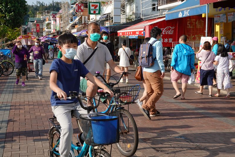 People wearing face masks are seen at Cheung Chau island during Easter weekend, amid the novel coronavirus disease (COVID-19) outbreak, in Hong Kong