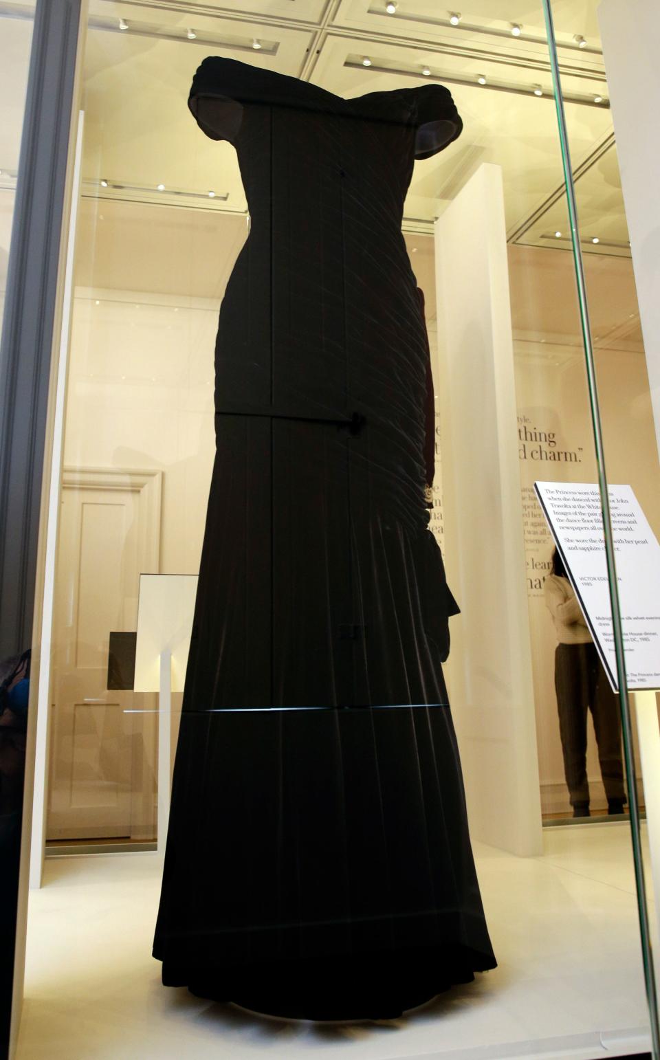 A Victor Edelstein dress in midnight blue silk velvet, worn by Diana Princess of Wales at a State Dinner at the White House in 1985, on display during a media preview of an exhibition of 25 dresses and outfits worn by Diana, Princess of Wales entitled "Diana: Her Fashion Story" at Kensington Palace in London, Wednesday, Feb. 22, 2017. (AP Photo/Alastair Grant) ORG XMIT: XAG101