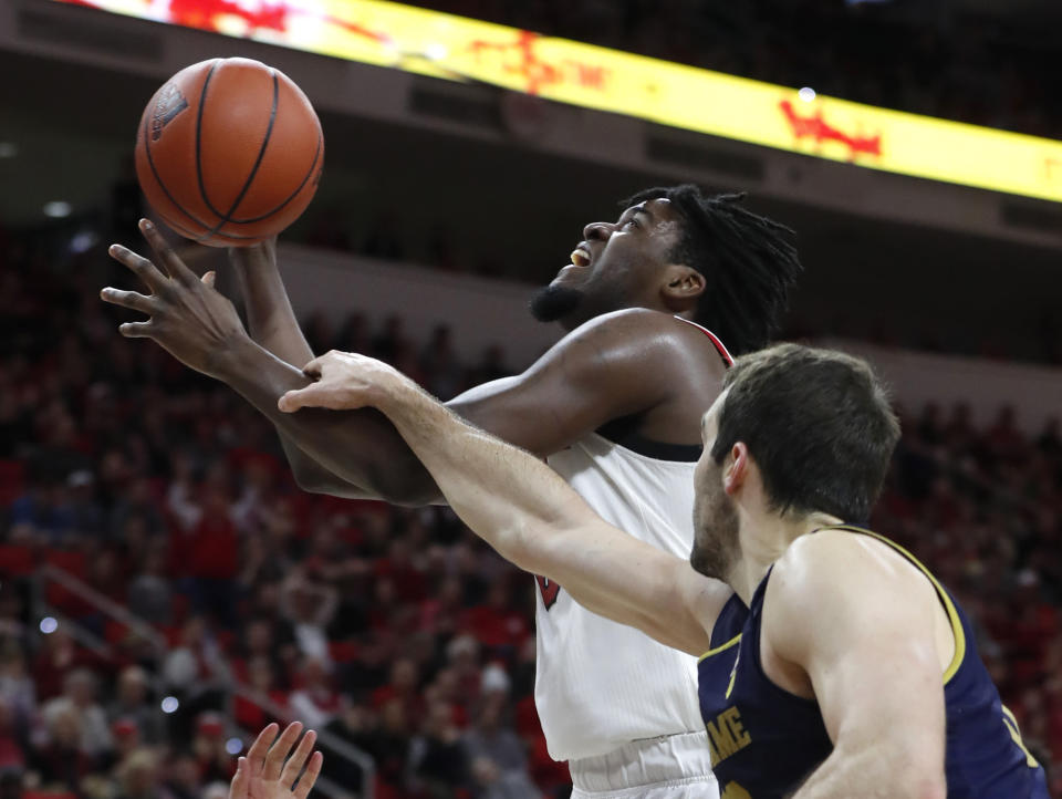 North Carolina State's D.J. Funderburk (0) is fouled by Notre Dame's John Mooney (33) during the second half an NCAA college basketball game in Raleigh, N.C., Wednesday, Jan. 8, 2020. (Ethan Hyman/The News & Observer via AP)