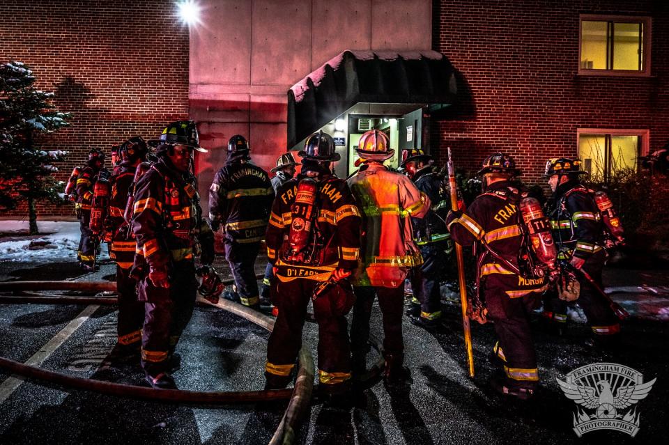 Firefighters enter 14 Temple St. in Framingham on Tuesday night to fight a two-alarm fire, Jan. 24, 2023.