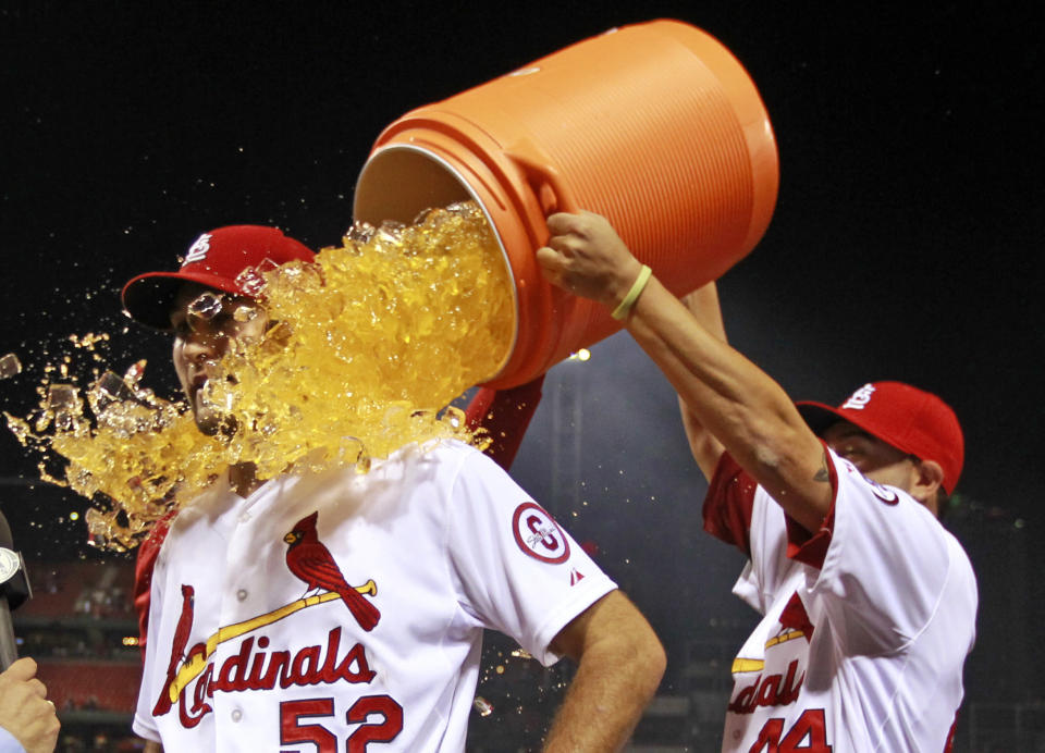 St. Louis Cardinals starting pitcher Michael Wacha is dunked by teammate Edward Mujica, right, following a baseball game against the Washington Nationals Tuesday, Sept. 24, 2013, in St. Louis. Wacha gave up a no-hitter with two outs in the ninth inning and the Cardinals won 2-0. (AP Photo/Jeff Roberson)