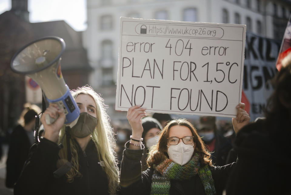 FILE - People attend a Climate Strike demonstration in Zurich, Switzerland, Nov. 6, 2021. The overarching phrase that dominates Glasgow climate talks is simply a number: 1.5. That's the chief but elusive goal of negotiations. It's keeping warming to 1.5 degrees Celsius since pre-industrial times. (Michael Buholzer/Keystone via AP, File)