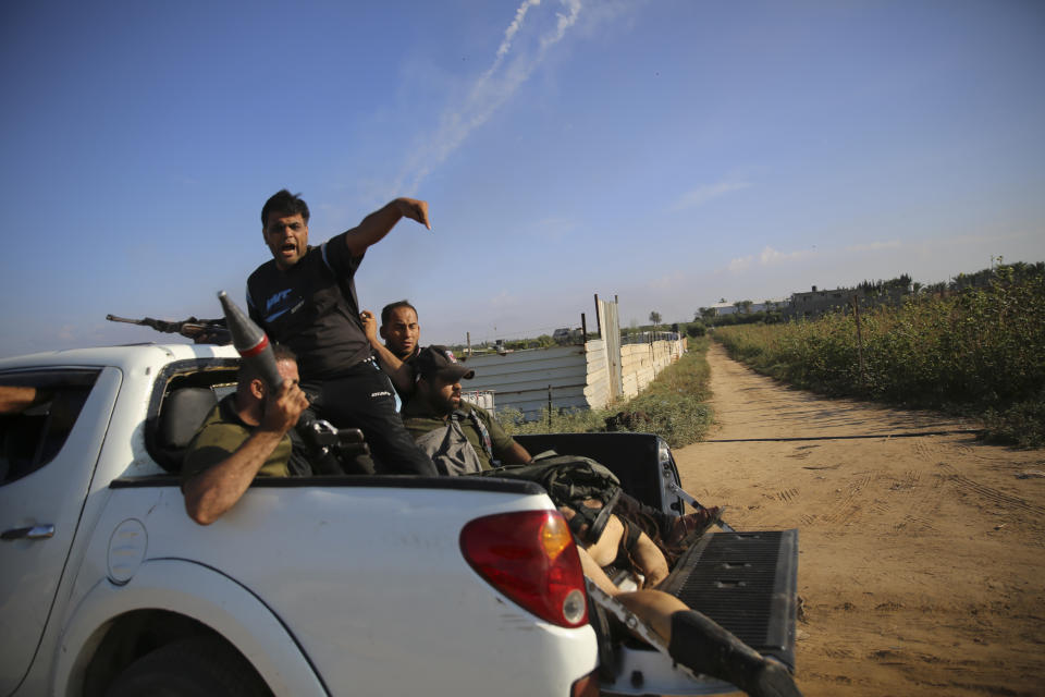 Palestinian militants drive back to the Gaza Strip with the body of Shani Louk, a German-Israeli dual citizen, on Saturday, Oct. 7, 2023. The militant Hamas rulers of the Gaza Strip carried out an unprecedented, multi-front attack on Israel at daybreak Saturday, firing thousands of rockets as dozens of Hamas fighters infiltrated the heavily fortified border in several locations by air, land, and sea and catching the country off-guard on a major holiday. (AP Photo/Ali Mahmud)