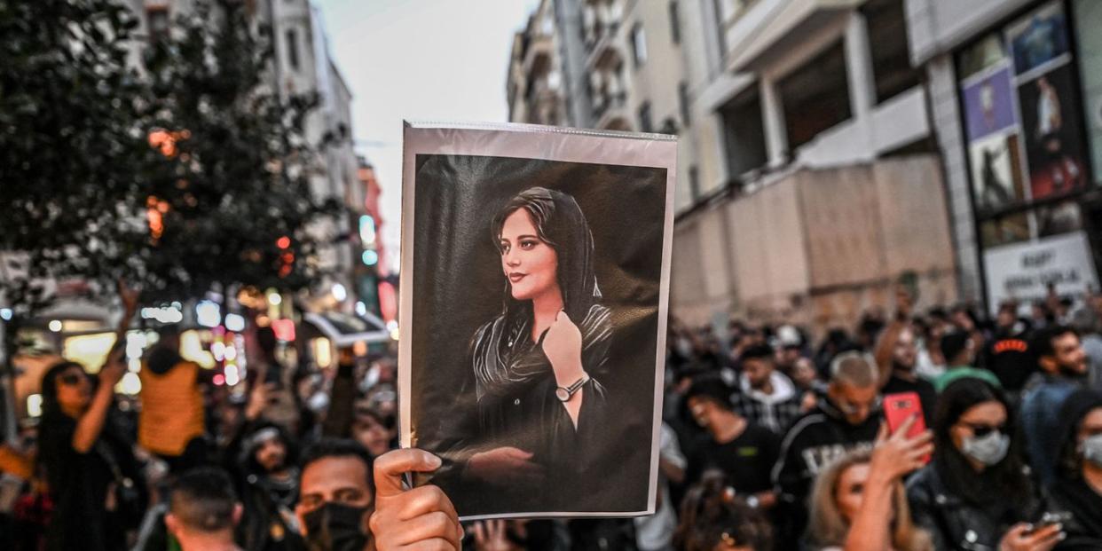 topshot a protester holds a portrait of mahsa amini during a demonstration in support of amini, a young iranian woman who died after being arrested in tehran by the islamic republic's morality police, on istiklal avenue in istanbul on september 20, 2022 amini, 22, was on a visit with her family to the iranian capital when she was detained on september 13 by the police unit responsible for enforcing iran's strict dress code for women, including the wearing of the headscarf in public she was declared dead on september 16 by state television after having spent three days in a coma photo by ozan kose afp photo by ozan koseafp via getty images