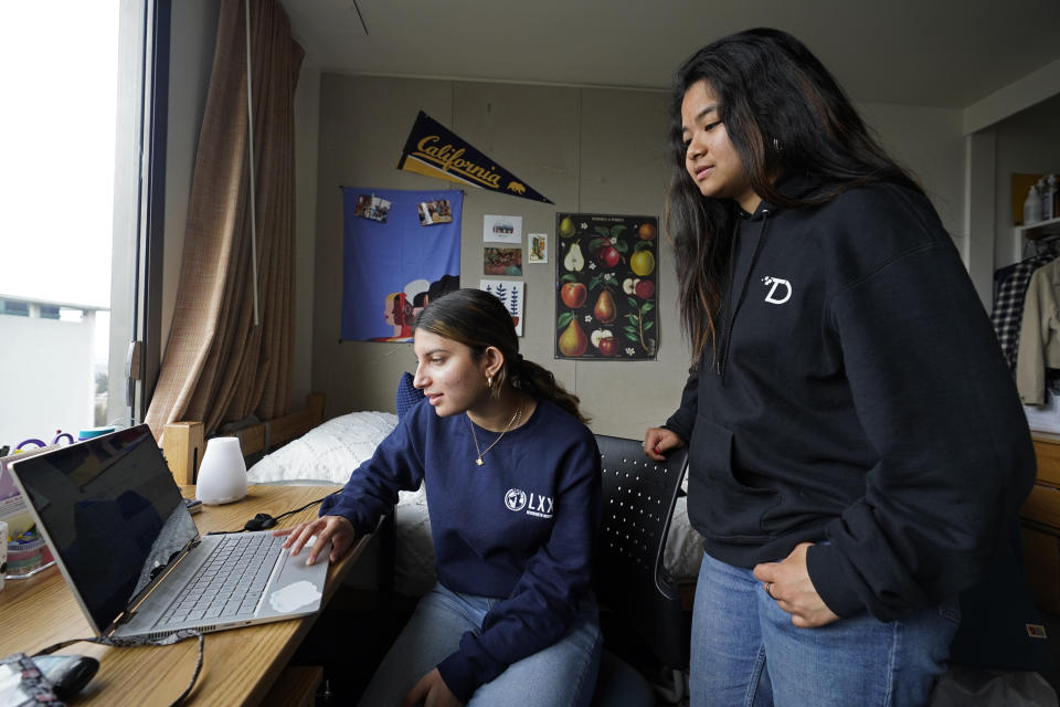 University of California, Berkeley freshmen Sanaa Sodhi, left, and Cheryl Tugade search listings for apartments in Berkeley, Calif., Tuesday, March 29, 2022. Millions of college students in the U.S. are trying to find an affordable place to live as rents surge nationally, affecting seniors, young families and students alike. Sodhi is looking for an apartment to rent with three friends next fall, away from the dorms but still close to classes and activities on campus. They've budgeted at least $5,200 for a two-bedroom. (AP Photo/Eric Risberg)