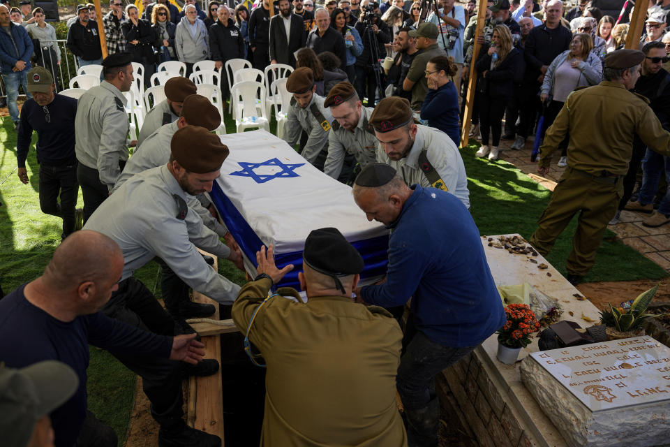 Israeli soldiers carry the flag-draped casket of Major Roei Meldasi during his funeral in Afula, Israel, Wednesday, Dec. 13, 2023. Meldasi, 23, was killed during a military ground operation in the Gaza Strip. (AP Photo/Ariel Schalit)