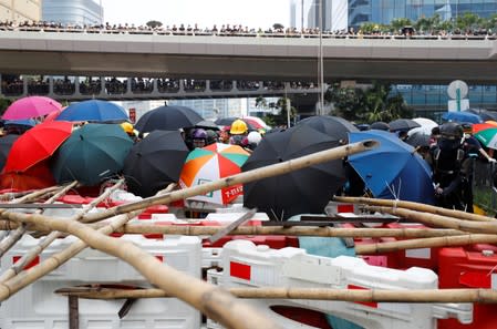 Demonstrators stand behind barricades during a protest in Hong Kong