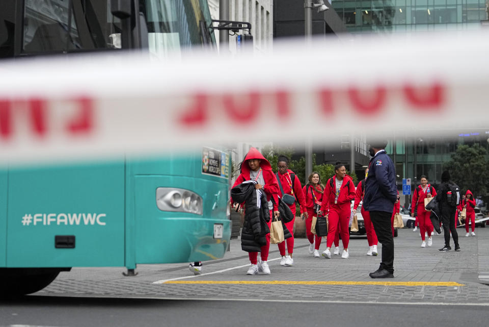 Members of the Philippines Women's World Cup team walk to their team bus following a shooting near their hotel in the central business district in Auckland,New Zealand, Thursday, July 20, 2023. A gunman killed two people before he died Thursday at a construction site in Auckland, as the nation prepared to host games in the FIFA Women's World Cup soccer tournament.(AP Photo/Abbie Parr)