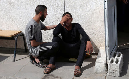 A relative of a Palestinian Islamic Jihad militant, who was killed in an Israeli tank shelling that targeted an observation post, reacts at a hospital in the southern Gaza Strip May 27, 2018. REUTERS/Ibraheem Abu Mustafa