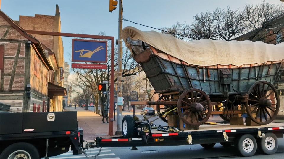 The Conestoga wagon passes the Golden Plough Tavern at Market and Pershing.