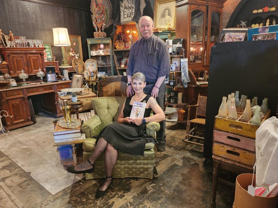 Author King Hill (standing) will host a book signing for his new book, "Under Patchouli Skies," in partnership with Aunt Eek's Books and Curiosities owner Angela Workman (sitting) on April 23.