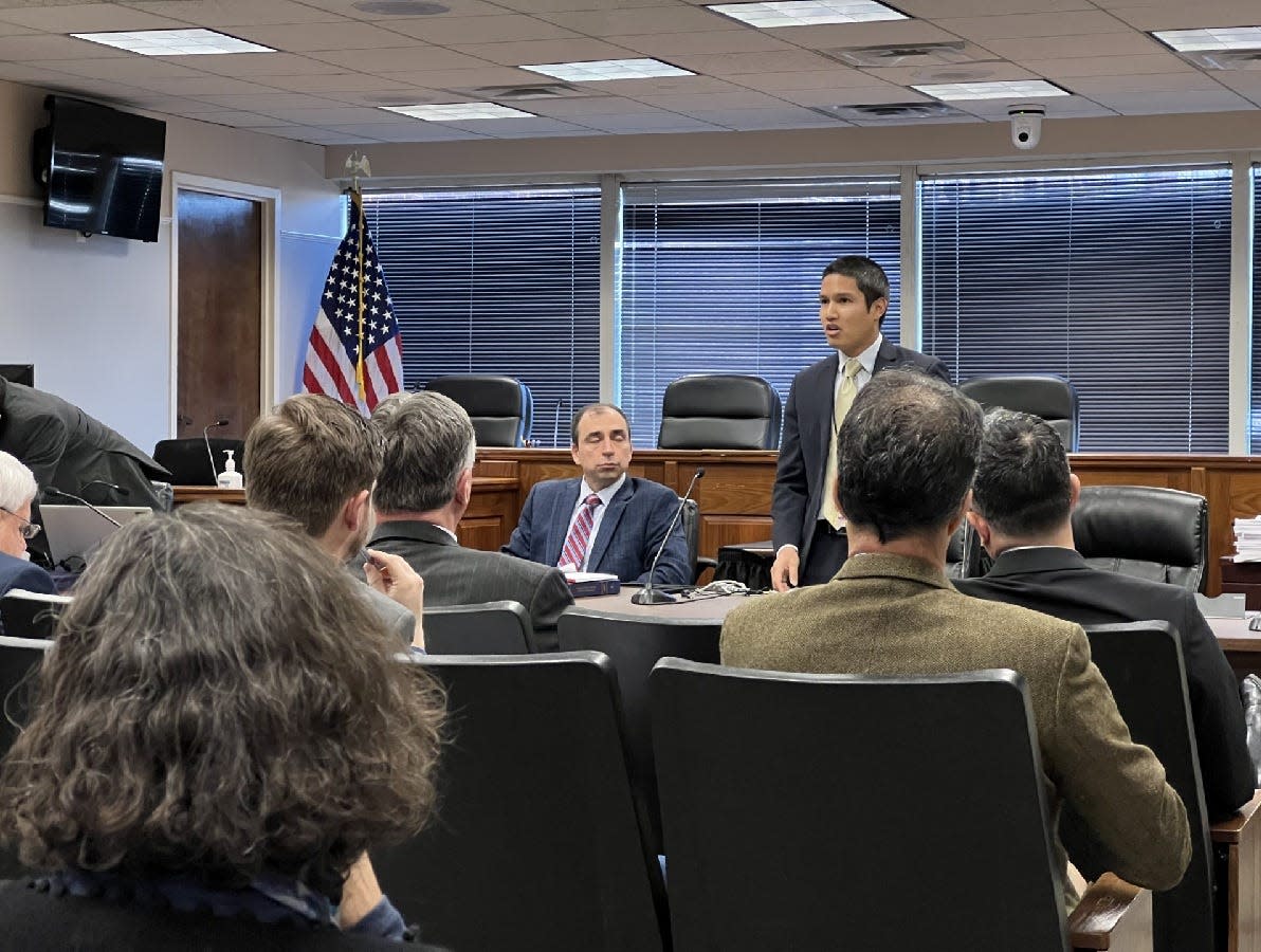 Maryland Public Service Commission Advisor David Chy, standing at right, opens with remarks at a conference where paths forward about the processes for solar development in the state were discussed at the commission's Baltimore headquarters Dec. 15, 2023.