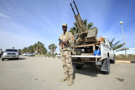 A member of the force assigned to protect Libya's unity government stands on a road leading to where the government has their offices, in Tripoli, Libya March 31, 2016. REUTERS/Ismail Zitouny