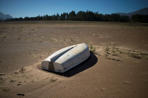 A picture taken on May 10, 2017 shows a boat lying on the sand at the Theewaterskloof Dam, which has less than 20% of it's water capacity, near Villiersdorp, about 108 km from Cape Town