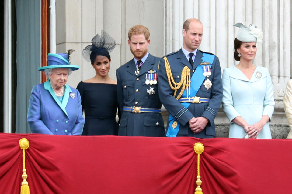 Queen Elizabeth II, Meghan, Duchess of Sussex, Prince Harry, Duke of Sussex, Prince William, Duke of Cambridge and Catherine, Duchess of Cambridge watch the RAF flypast on the balcony of Buckingham Palace, as members of the Royal Family attend events to mark the centenary of the RAF on July 10, 2018 in London, England.