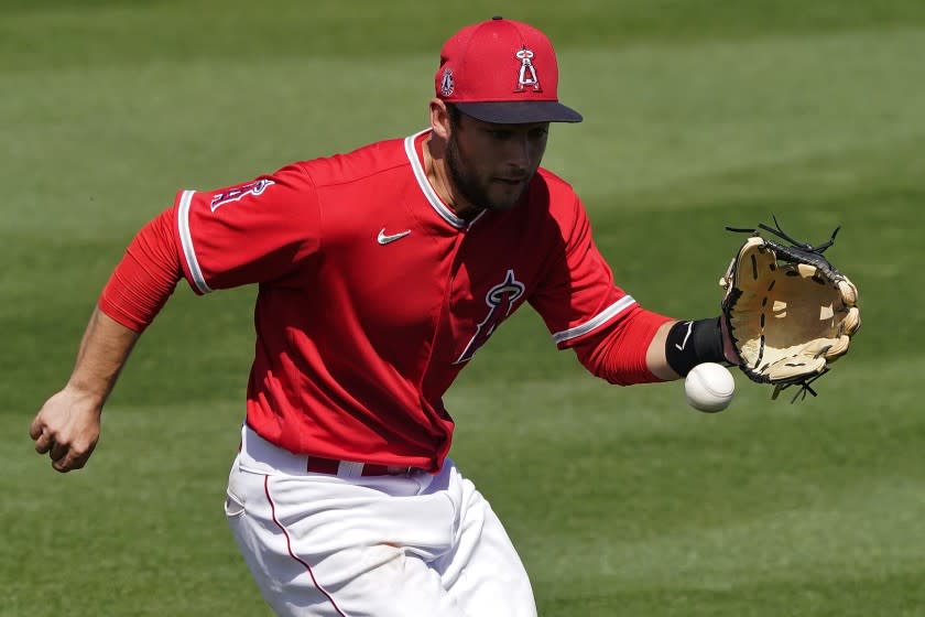 Los Angeles Angels' David Fletcher fields a base hit by Oakland Athletics' Elvis Andrus during the third inning of a spring training baseball game, Saturday, March 20, 2021, in Tempe, Ariz. (AP Photo/Matt York)