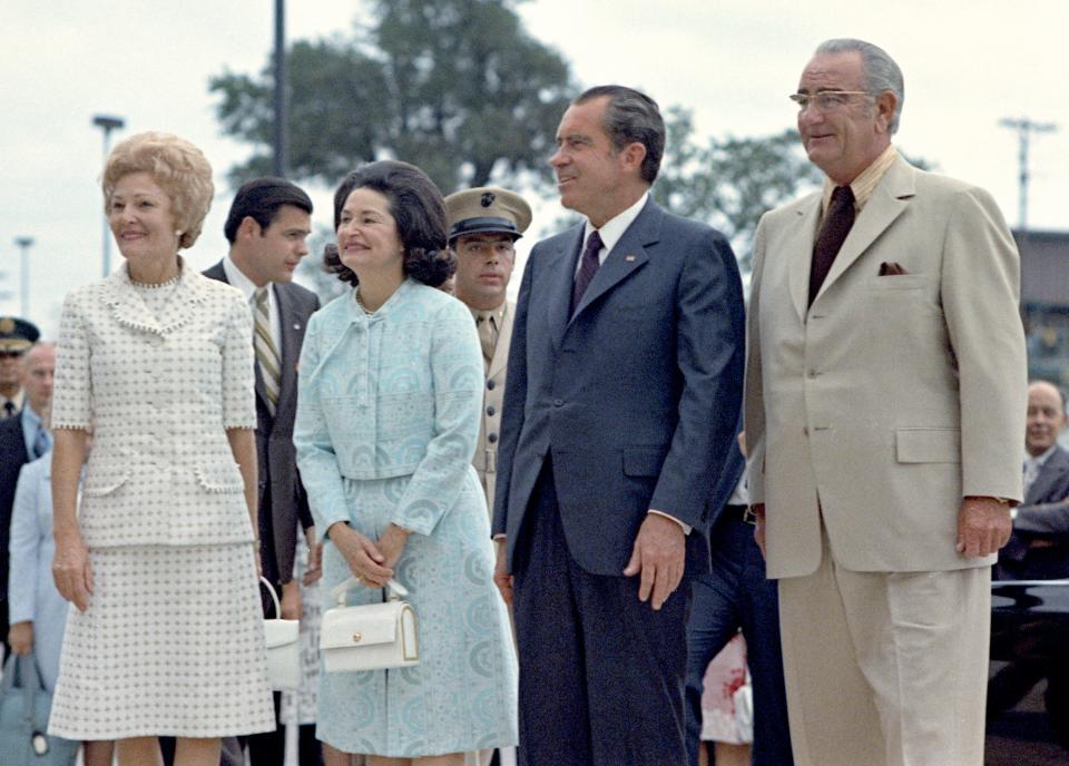 First Lady Pat Nixon, left, and President Richard Nixon are greeted by President Lyndon B. Johnson and Lady Bird Johnson when they arrived for the dedication of the LBJ Library in Austin on May 22, 1971.