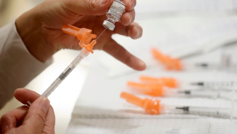 A Salt Lake County Health Department employee prepares Pfizer COVID-19 booster shots at a free vaccine clinic at the Sanderson Community Center in Taylorsville on Nov. 9, 2022.