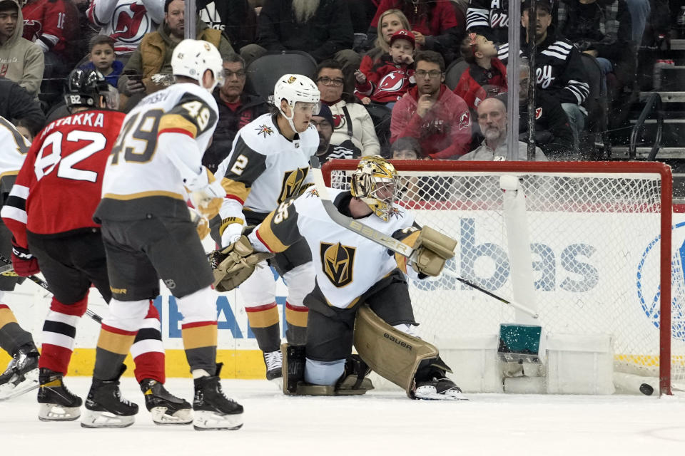 Vegas Golden Knights goaltender Logan Thompson (36) watches as a shot by New Jersey Devils center Nico Hischier gets past him for a goal during the first period of an NHL hockey game, Monday, Jan. 22, 2024, in Newark, N.J. (AP Photo/Mary Altaffer)