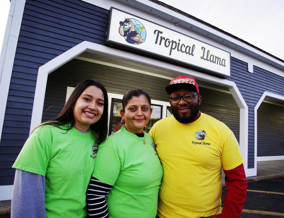 From left, Jendi Roque and her parents Sandra Roque and Johan Martinez stand in front of their new restaurant Tropical Llama in Raynham on Jan. 6, 2022.