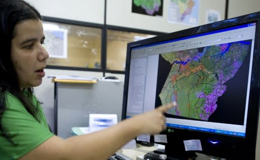 Priscila Santos, a Brazilian Environmental Intitute geographer, points at a satellite map to detect deforestation areas in Para state, northern Brazil, on November 27, 2009