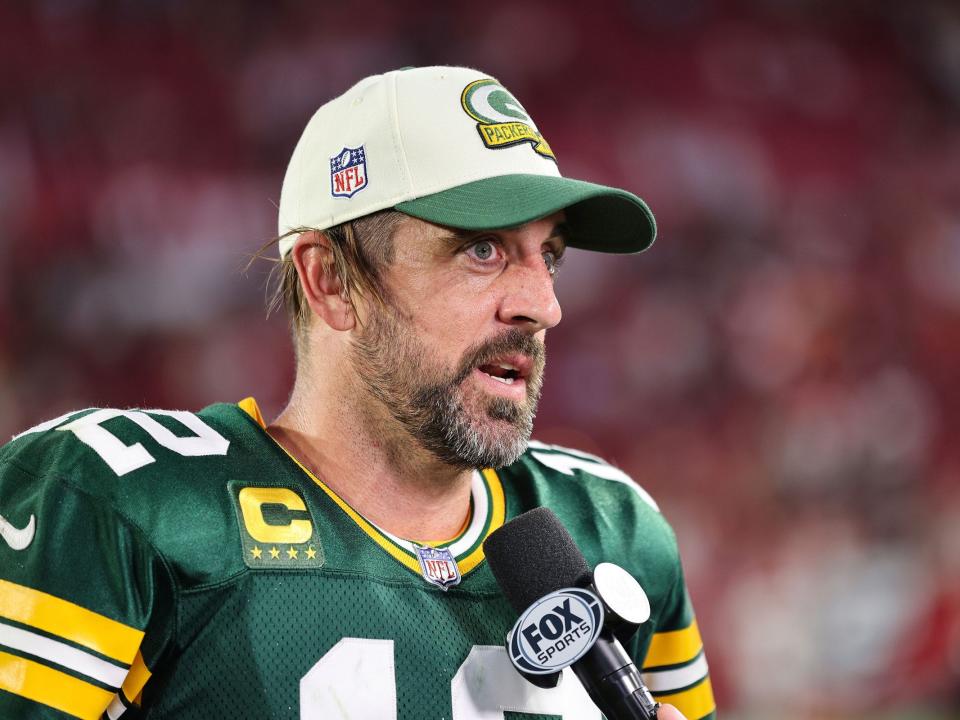 Aaron Rodgers speaks with a reporter after a win against the Tampa Bay Buccaneers.