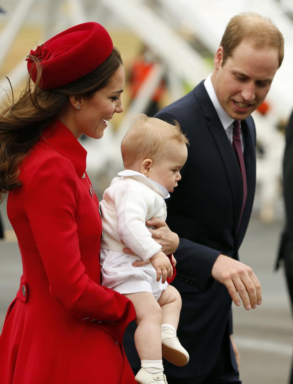 Britain's Prince William, his wife Catherine and their son Prince George disembark from their plane after arriving in Wellington