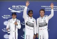 Formula One - F1 - British Grand Prix 2015 - Silverstone, England - 4/7/15 Mercedes' Lewis Hamilton celebrates his pole position in qualifying with Mercedes' Nico Rosberg (R) and Williams' Felipe Massa (L) Reuters / Phil Noble Livepic